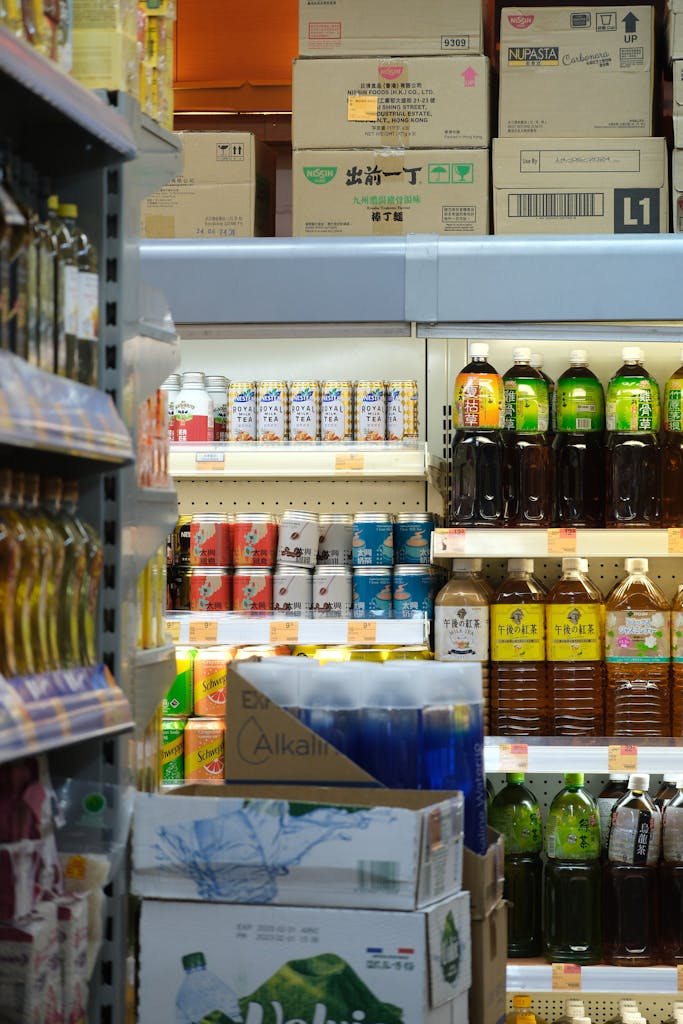 Bottles and cartons of drinks on supermarket shelves offering a diverse selection.